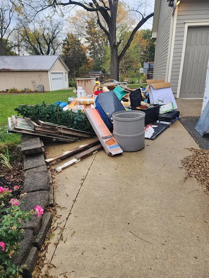 Dumpster being loaded with debris for Commercial Dumpster Rental in Myrtle Creek